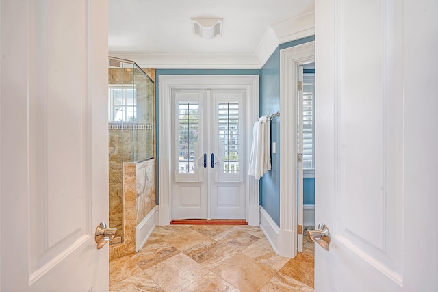 entrance foyer featuring french doors, crown molding, and baseboards