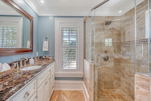 full bathroom with ornamental molding, a wealth of natural light, a stall shower, and vanity