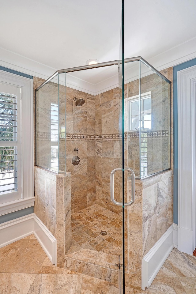 full bath featuring a stall shower and crown molding