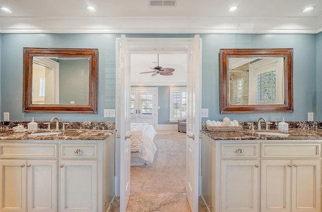 ensuite bathroom with two vanities, a sink, and visible vents