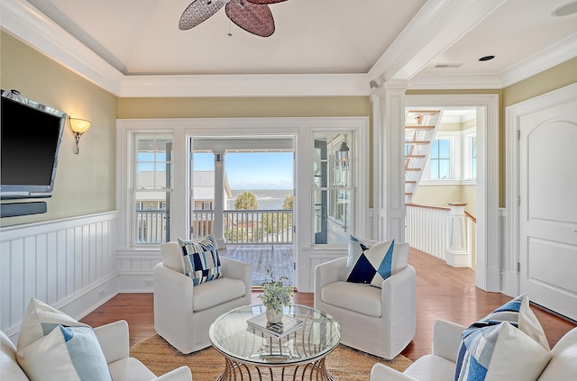 sunroom / solarium featuring visible vents, ceiling fan, lofted ceiling, and decorative columns