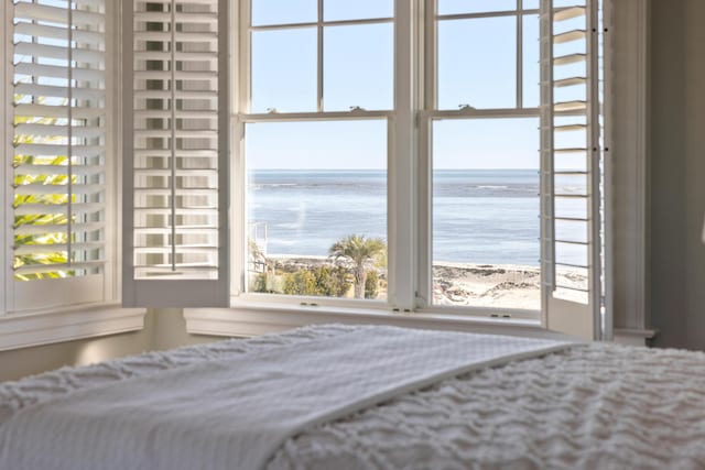 unfurnished bedroom with a beach view and a water view