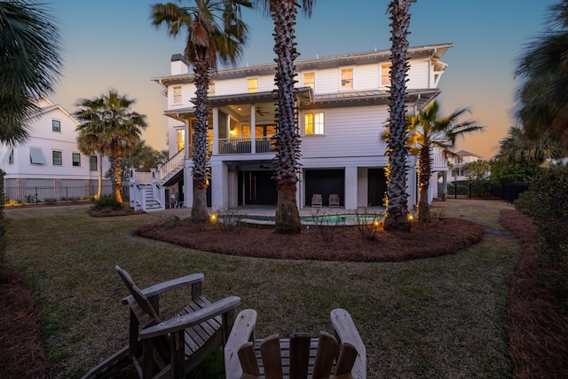 rear view of property featuring a patio, a lawn, stairway, fence, and ceiling fan