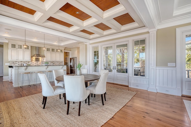 dining area featuring french doors, coffered ceiling, beamed ceiling, and light wood-style flooring