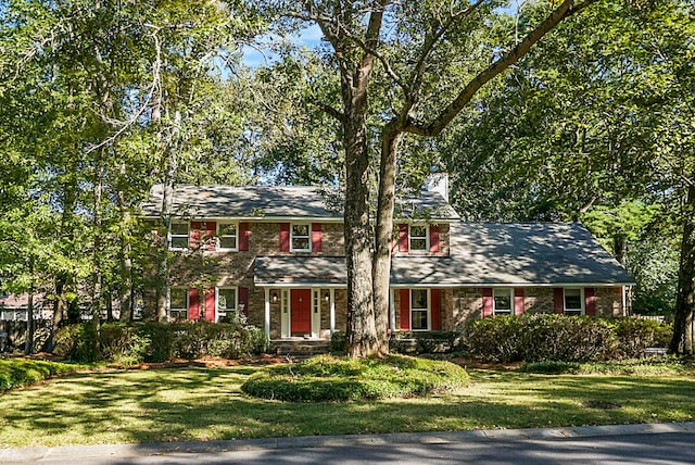 colonial-style house with a front lawn