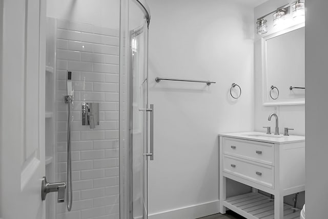 bathroom with vanity and a shower with door