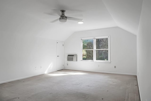 additional living space with ceiling fan, a wall unit AC, and lofted ceiling