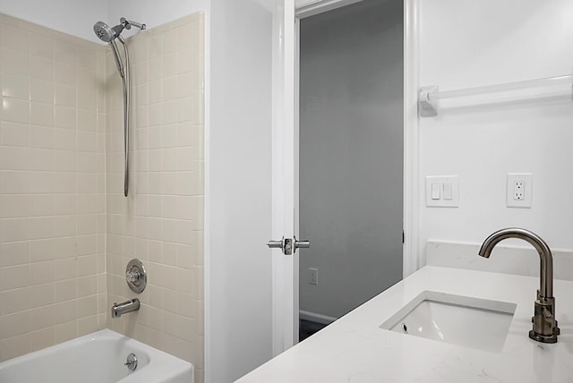 bathroom with vanity and tiled shower / bath combo