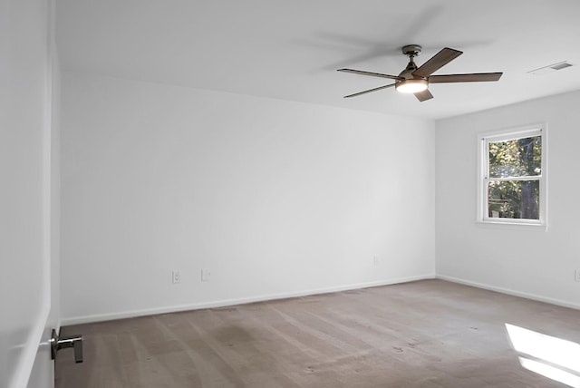 carpeted spare room with ceiling fan