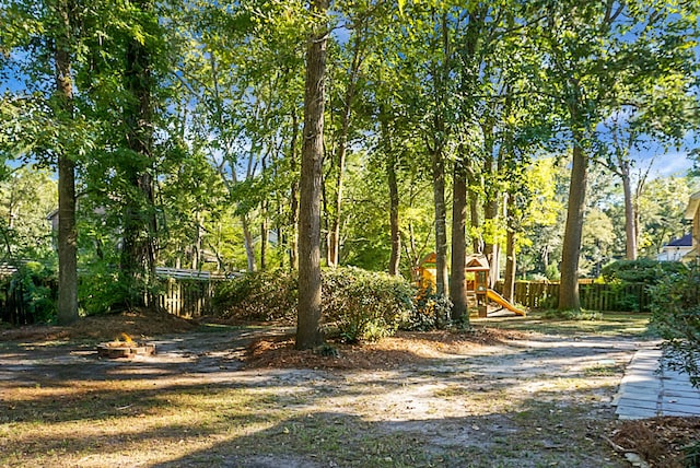 view of yard with a playground and an outdoor fire pit