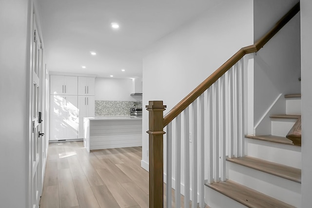 stairs with hardwood / wood-style flooring