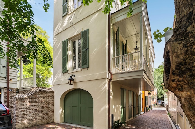 view of property exterior featuring stucco siding and a balcony