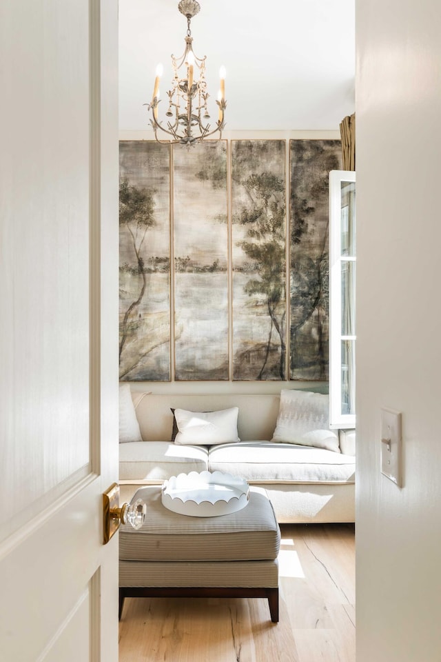 sitting room featuring a chandelier and wood finished floors