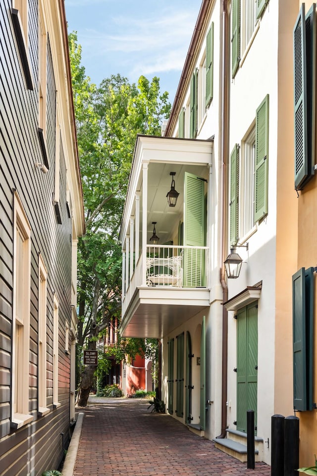 view of property exterior featuring stucco siding and a balcony