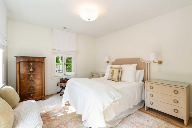 bedroom featuring visible vents and light wood-style floors