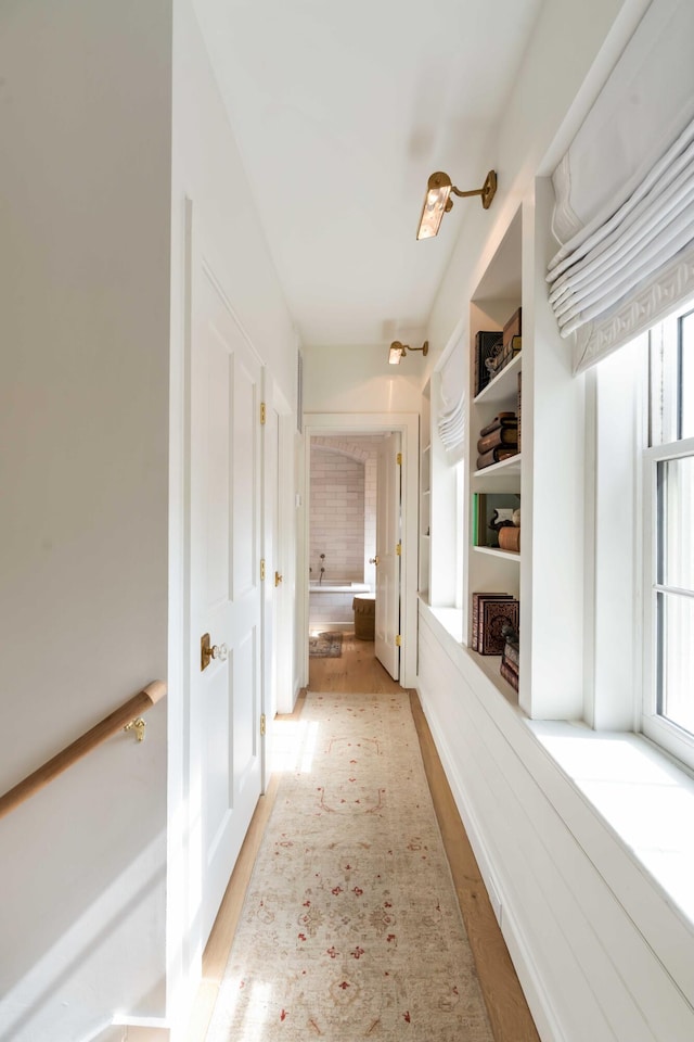 corridor with light wood-type flooring