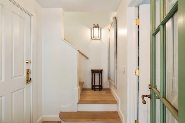 stairway featuring baseboards and wood finished floors