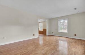 unfurnished room with light wood-type flooring