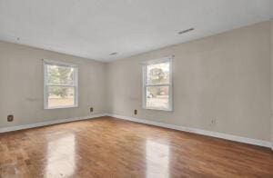 unfurnished room featuring hardwood / wood-style flooring