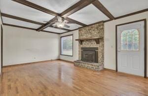 unfurnished living room with a fireplace, coffered ceiling, ceiling fan, wood-type flooring, and beamed ceiling