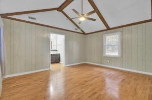 spare room featuring ceiling fan, light hardwood / wood-style flooring, and lofted ceiling with beams