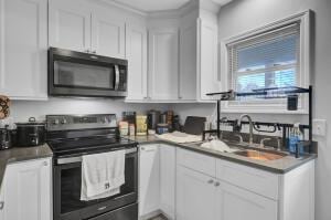 kitchen featuring white cabinets, sink, and stainless steel appliances