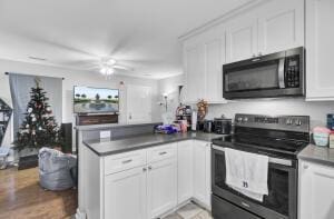 kitchen with white cabinetry, stainless steel range with electric cooktop, and ceiling fan