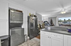 kitchen with stainless steel refrigerator with ice dispenser, white cabinetry, and ceiling fan