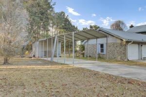 view of vehicle parking with a garage and a carport