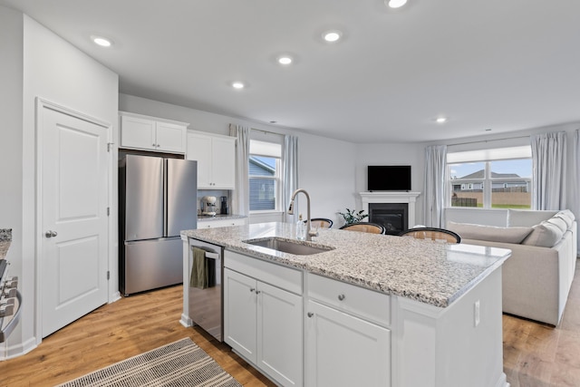 1173 Wading Point Blvd, Huger, SC 29450 - kitchen with appliances with stainless steel finishes, a sink, open floor plan, healthy amount of natural light, and recessed lighting