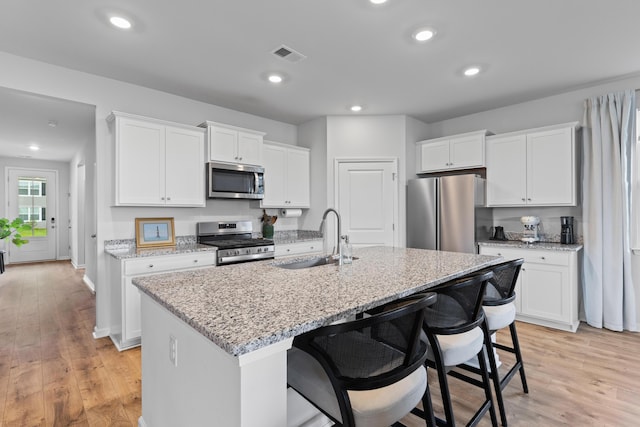 1173 Wading Point Blvd, Huger, SC 29450 - kitchen with a sink, appliances with stainless steel finishes, white cabinetry, an island with sink, and recessed lighting