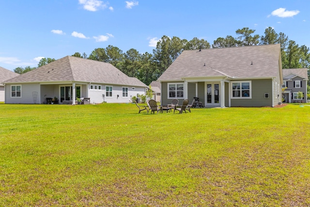 1173 Wading Point Blvd, Huger, SC 29450 - back of house featuring french doors, a yard, a fire pit, and roof with shingles