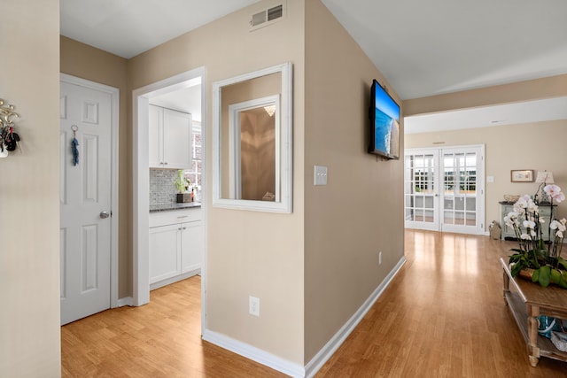 corridor with light hardwood / wood-style floors