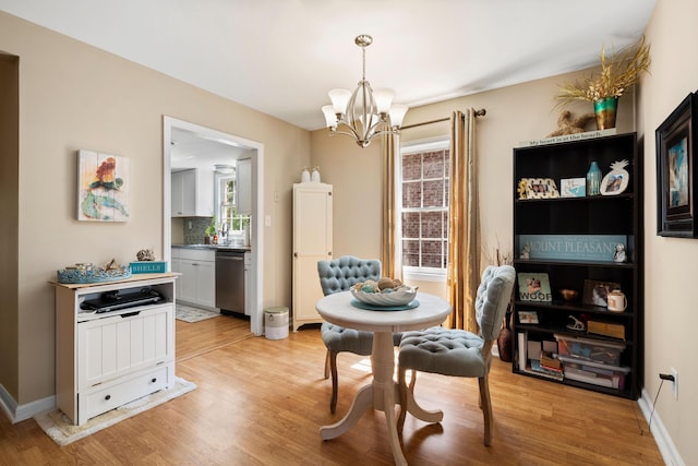 dining room with an inviting chandelier and light wood-type flooring