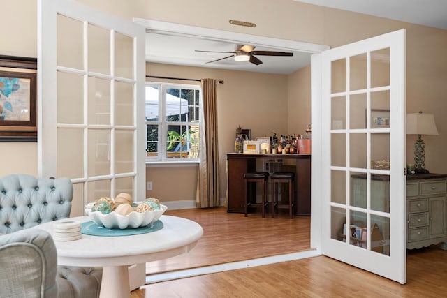 dining space with wood-type flooring and ceiling fan