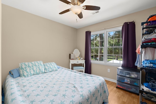 bedroom with light wood-type flooring and ceiling fan