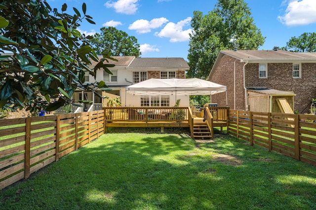 rear view of house featuring a yard and a deck