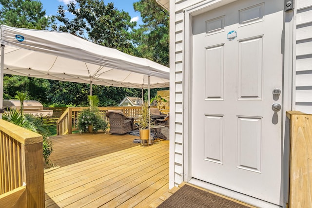 wooden terrace featuring a gazebo and grilling area