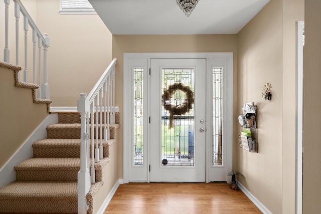 entrance foyer featuring light hardwood / wood-style flooring and a healthy amount of sunlight