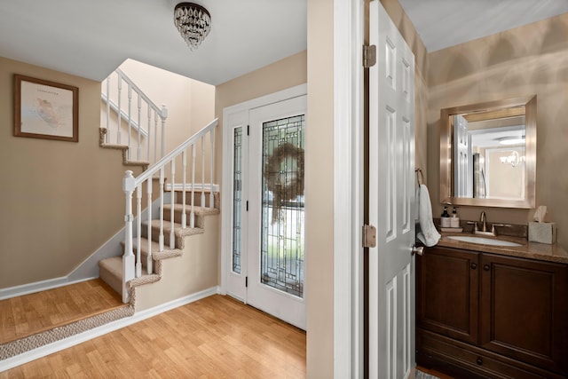 entryway with sink and light hardwood / wood-style floors