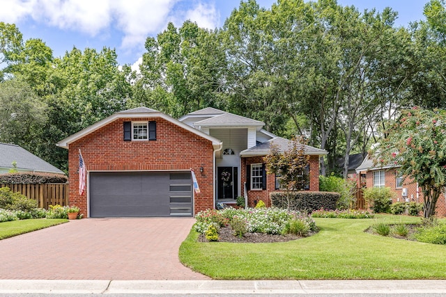 view of property featuring a garage and a front lawn