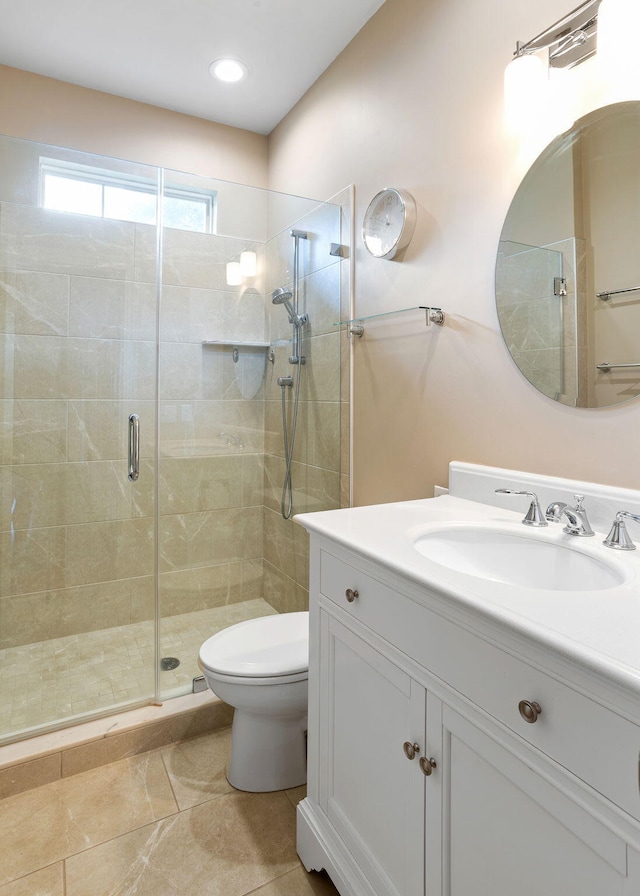 bathroom with walk in shower, toilet, and vanity