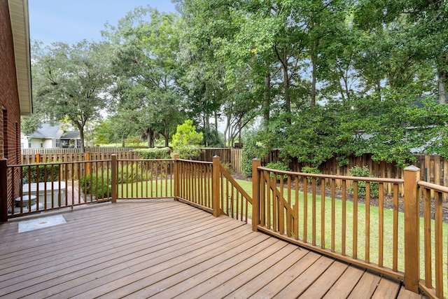 wooden deck with a lawn