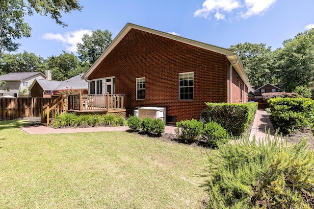 back of property featuring a yard and a deck