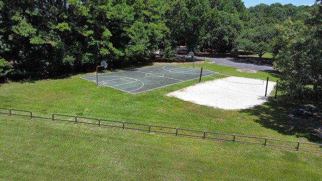 view of sport court featuring a yard