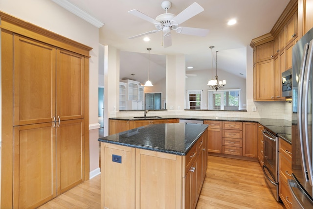 kitchen with a center island, vaulted ceiling, ceiling fan with notable chandelier, and kitchen peninsula