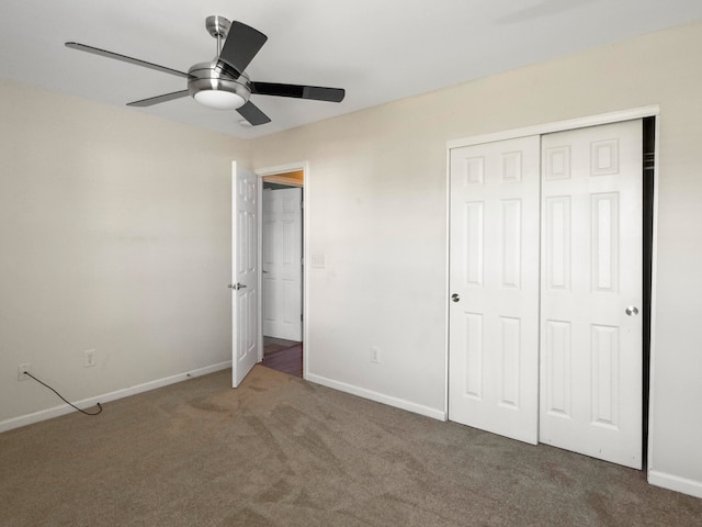 unfurnished bedroom with ceiling fan, a closet, and carpet floors