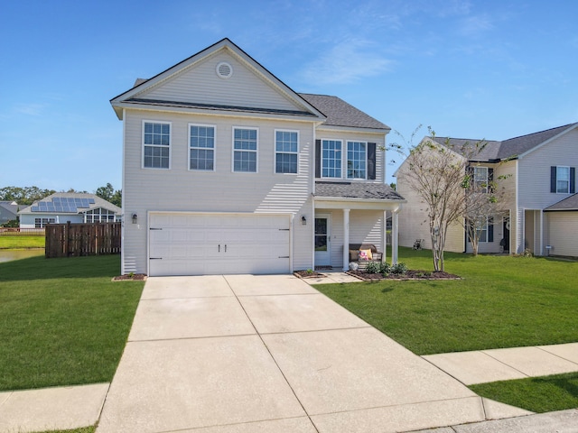 view of front of house with covered porch, a front yard, and a garage