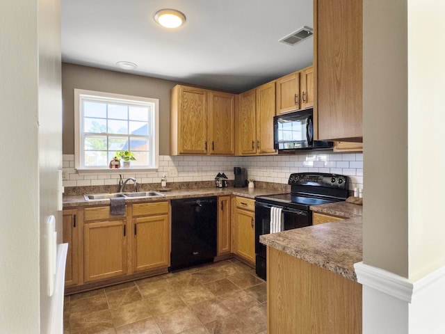 kitchen with black appliances, decorative backsplash, and sink