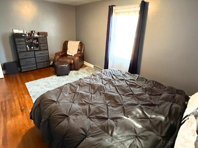 bedroom with dark hardwood / wood-style floors